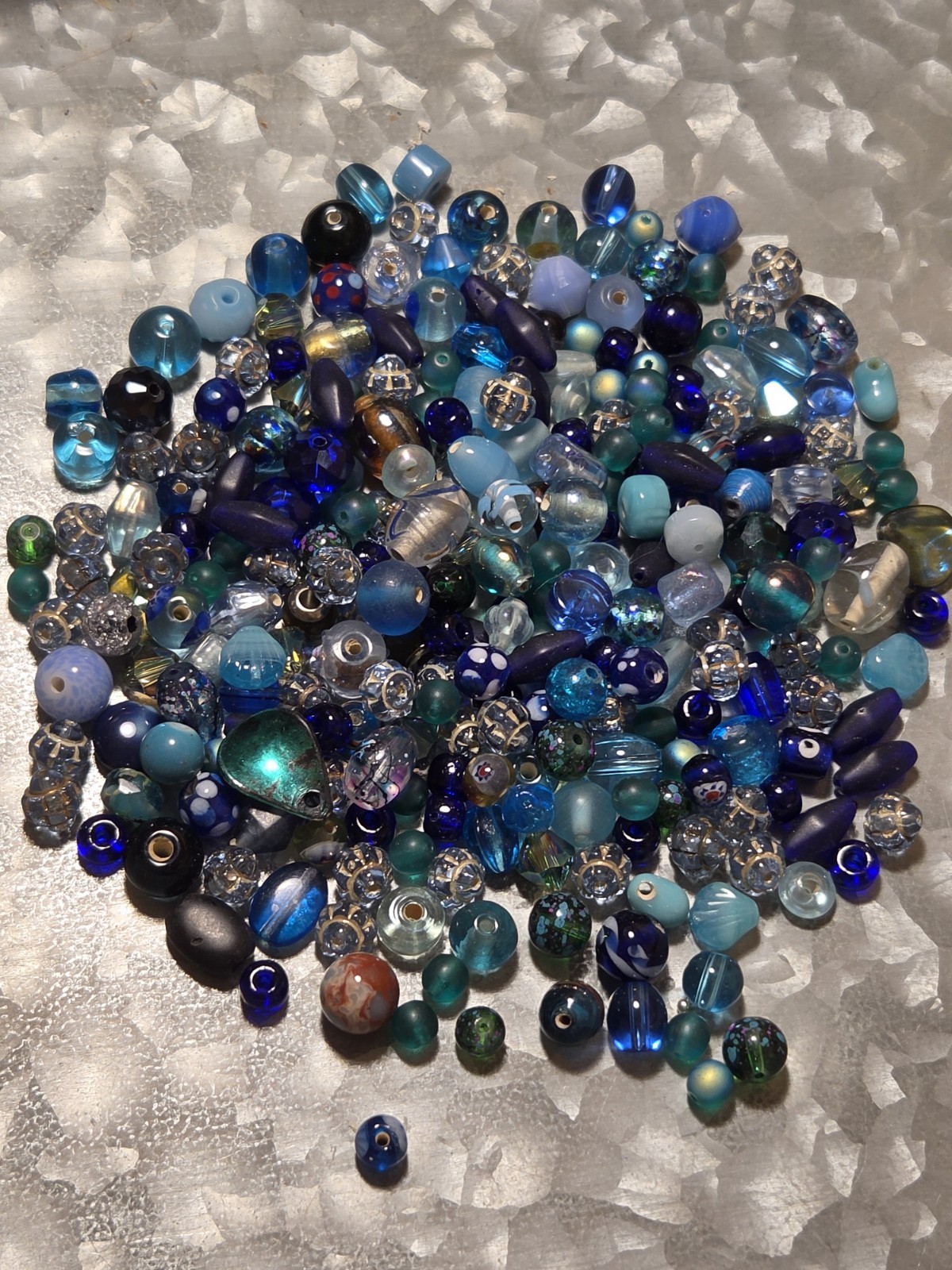 5 OZ. QUARTER PINT JAR OF SMALL TO MEDIUM VINTAGE VARIETY OF BLUE GLASS BEADS