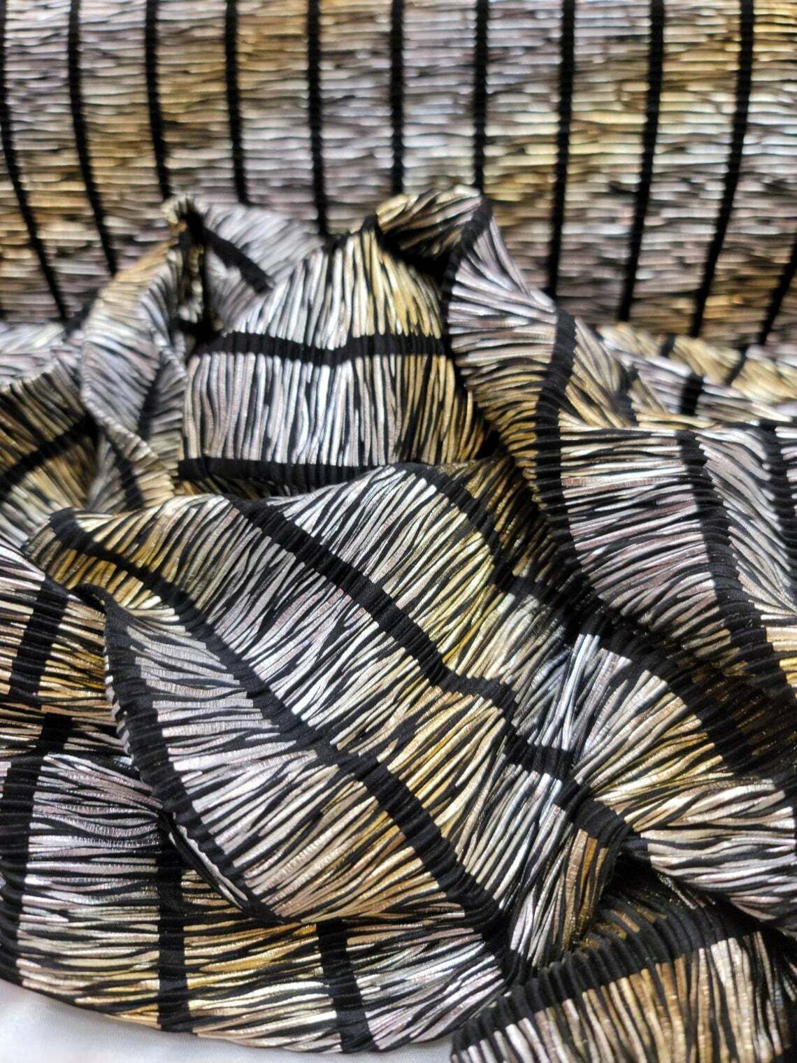 Metallic Gold and Silver Pleated Stretch Spandex On Black Textured Fabric