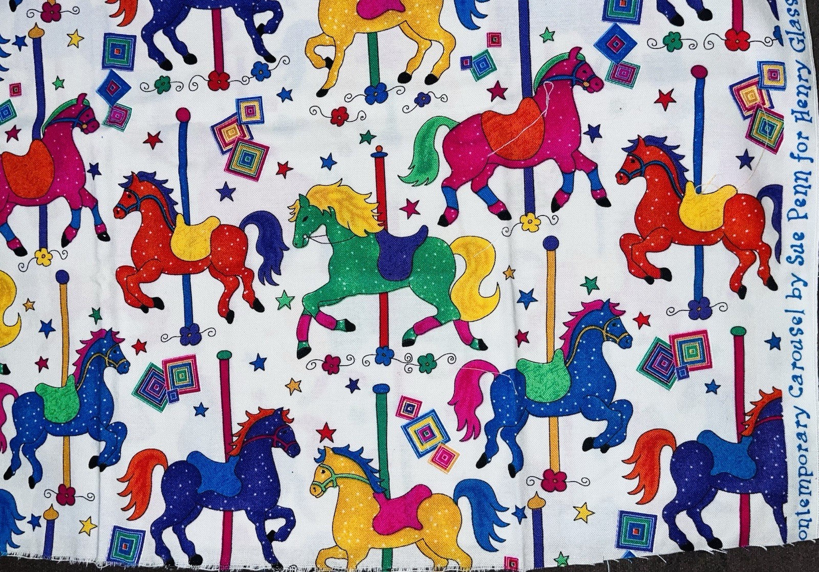 Contemporary Carousel Primary Colors by Sue Penn for Henry Glass Co. 22″X 12″